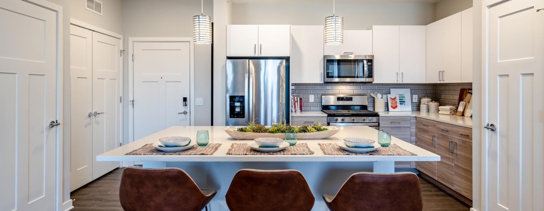 a kitchen with an island and chairs