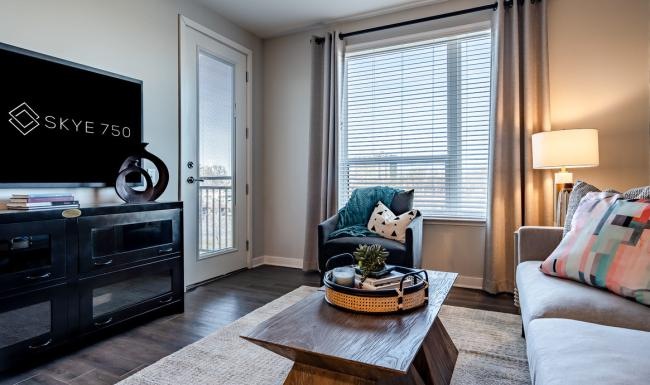 Generous living spaces with beautiful natural lighting a living room with a tv and couches
